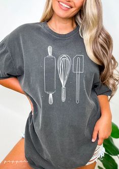 "Baking Tools Comfort Colors Shirt - Baking Shirt, Baking TShirt, Baker T-Shirt, Gift for Baker Shirt, Cake Maker Shirt, Cookie Baking Shirt The perfect tee for all the baking enthusiasts out there! ✦ Fit + Quality ✦ These soft, comfy tees wash well and are easy to wear! ✦ 100% ringspun cotton ✦ Preshrunk, soft-washed, garment-dyed fabric ✦ Twill taped shoulder-to-shoulder ✦ Set-in sleeves ✦ Double-needle stitched sleeves and bottom hem ✦ 1\" ribbed collar with double-needle topstitched neckline Washing & Drying Instructions: ✦ Turn inside out. ✦ Wash with cold/warm water. ✦ Do not use bleach. ✦ Don't recommend tumble dry, hang dry or lay flat to dry. ✦ Returns + Shipping ✦  We print on demand and custom print products - because of this, we are not accepting returns. If there are any defec Baking Tshirt, Tool Shirt, Cupcake Shirt, Chef Shirt, Shirt Cake, Baker Shirts, Chef Shirts, Cricut Shirts, Cake Maker