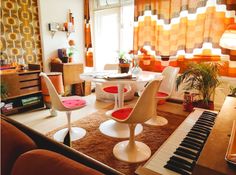 a living room filled with furniture and a piano