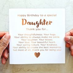 two hands holding a card that says, happy birthday to a special daughter thank you for