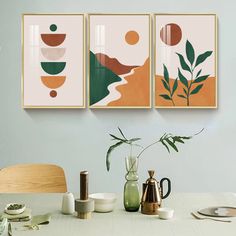 three paintings hanging on the wall above a dining room table