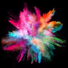 colorful powder exploding in the air on a black background