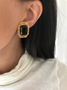 Vintage Antiqued Gold Plated Etruscan Revival Clip On EarringsWith "Onyx" Black Faceted Gem in the center of an ornate embellished frameThe earrings measure 1" x 3/4"They are new old stock earrings from the 1980s and are in great vintage condition. Important: Please read all shop policies prior to purchase.The below is a brief overview, to view full shop policies please go to the homepage of the shop and scroll to the bottom and they are listed in full there.International orders: Items may be su Vintage Black Earrings, Diy Statement Earrings, Baroque Jewelry, Black Bob, Vintage Clip On Earrings, Rings Bands, Faceted Gems, Costume Earrings, Gold Statement Earrings