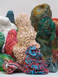 many different types of knitted objects on a white surface