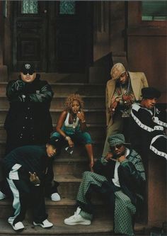 a group of people sitting on the steps in front of a building