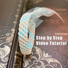 the book is open to show how to make a beaded bracelet with ribbon on it