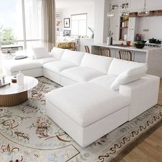 a large white couch sitting in a living room on top of a rug