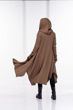 Wool Cape, Knit Cardigan, Cloak with HoodThis asymmetrical and modern cloak with hood has two side pockets, super comfy hood and thumb holes for a fabulous look.The model in the picture is 176cm. ⅼ 5.8 ft. tall and is wearing size S / color: Camel🌟 INFO:• Worldwide EXPRESS shipping – please provide a phone number for shipping documents• US Sizing XS to 4XL – body size chart available below• We offer customization to Personal Measurements & Larger Sizes 5XL, 6XL, 7XL ….🌟 MATERIAL & CARE Cape Reference, Sundance Clothing, Fabric Reference, Cloak With Hood, Pagan Fashion, Winter Cloak, Camel Wool Coat, Sweater Cape, Asymmetrical Cardigan