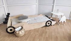 a child's bed made out of cardboard with wheels