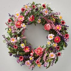 a floral wreath with pink, purple and yellow flowers