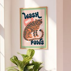 a plant is sitting in front of a poster on the wall that says wash your paws