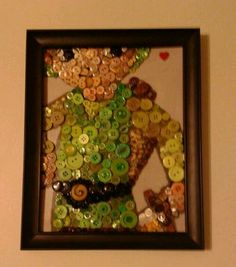 there is a framed picture made out of buttons