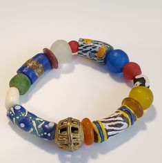 Beautiful Stretch Bracelet Made From African Sea Glass Beads, Colors Of Yellow, Blue, Green And Red. One Brass Filigree Medium Bead Assorted Colors Krobo Beads Measures Stretch Bracelet Measures 5" To - 6" Long, Wrist Baddie Bags, African Trade Bead Jewelry, African Beaded Bracelets, Krobo Beads, African Bracelets, Beads Colors, Sea Glass Beads, Bracelet Inspo, Earthy Jewelry