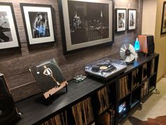 a record player sitting on top of a table next to a cd player and speakers