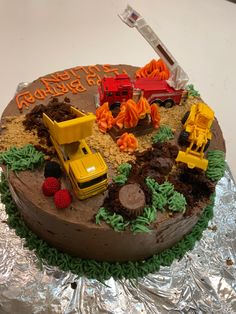 a birthday cake with construction vehicles on it