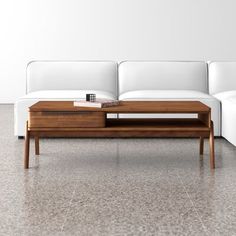 a white couch sitting next to a wooden coffee table