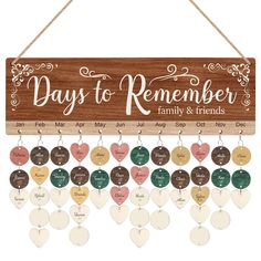 a wooden sign that says days to remember family and friends with hearts hanging from it