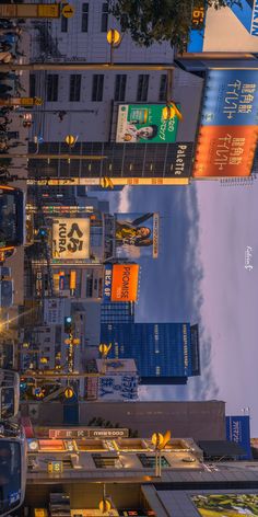 an overhead view of the city with tall buildings and billboards on it's sides