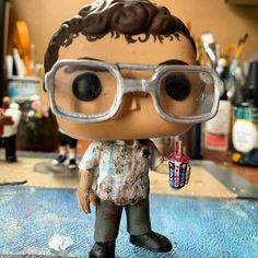 a close up of a toy with glasses on