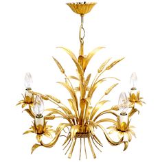 a golden chandelier hanging from the ceiling with three lights on each side and one light in the middle