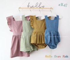 four baby rompers hanging on a clothes line with the word hello written above them