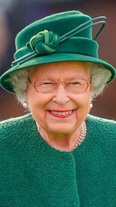 an older woman wearing a green hat and glasses