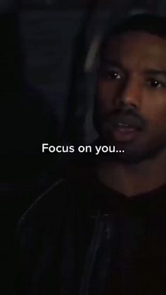 a man is staring at the camera with an ad in front of him that says focus on you