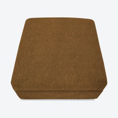 the footstool is made out of fabric, and has a brown cover on it