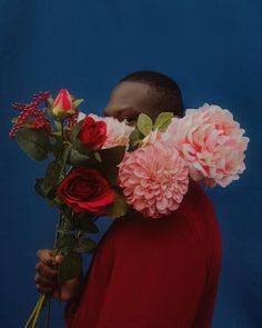 a man with flowers in his mouth