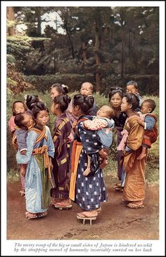 a group of women standing next to each other on a dirt road in front of trees