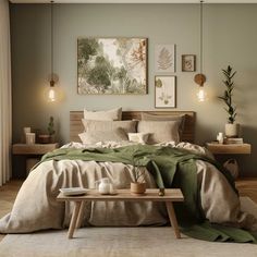 a bedroom with a bed, table and pictures on the wall above it in neutral colors