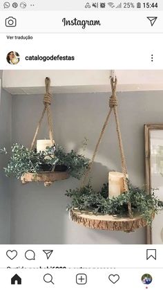 two hanging planters with candles and greenery on them in the corner of a room