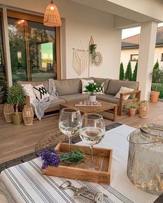 two wine glasses sitting on top of a wooden tray