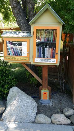 a little library in the shape of a tree