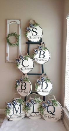 a christmas tree made out of plates with monogrammed letters and wreaths on them