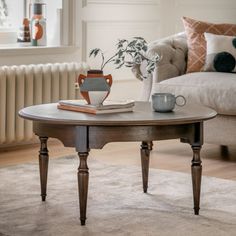 a coffee table sitting on top of a rug next to a couch