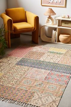 a living room with a yellow chair and rug