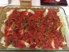 a casserole dish with meat and vegetables in it sitting on a counter top