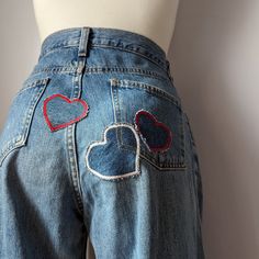 a woman's jeans with hearts on the back