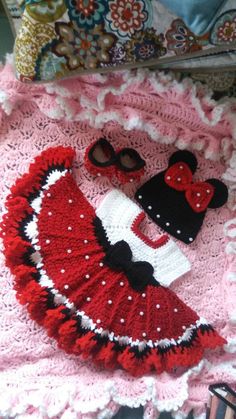 a crocheted blanket with minnie mouse and hat on it next to a pair of sunglasses