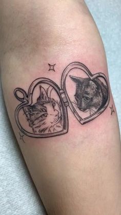 a cat in a heart shaped photo frame tattoo on the leg with a kitten inside