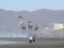 blurry image of two people riding horses in front of mountains and water with hills in the background