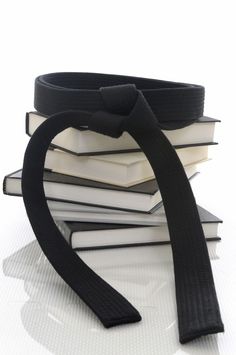 a stack of books with a black ribbon on top