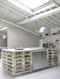 a kitchen with an island made out of wooden pallets