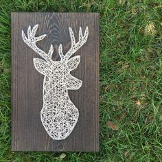 a wooden sign with a deer head on it