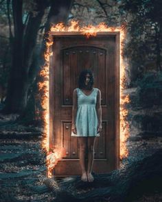 a woman standing in front of an open door with fire coming out of the doors