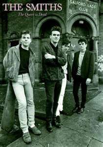 four young men standing in front of a brick building