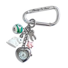 a key chain with a clock and charms attached to it