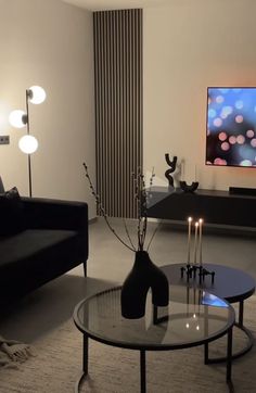 a living room filled with furniture and a flat screen tv mounted to the side of a wall