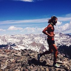 a man running on top of a rocky mountain