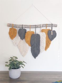 the wall hanging is decorated with different colored leaves